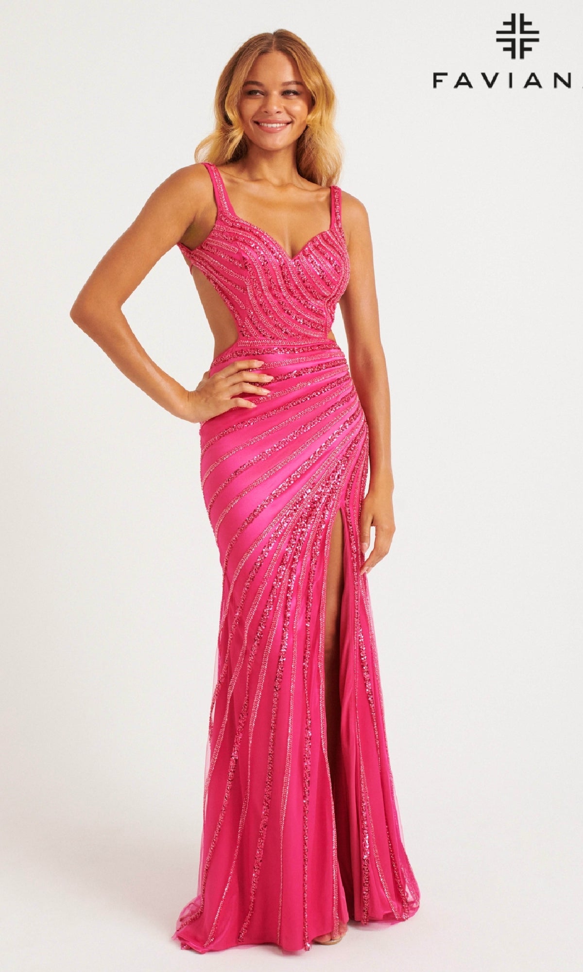 A woman models the Faviana 11243 long prom dress in hot pink, featuring a fitted, sleeveless design with glittering diagonal stripes, cut-out sides, open back, and front slit. She stands against a white background with the